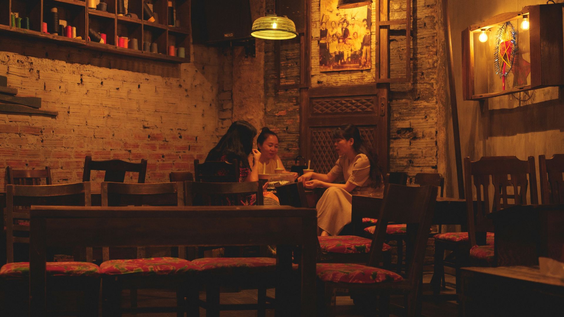 a person and a child sitting at a table in a restaurant