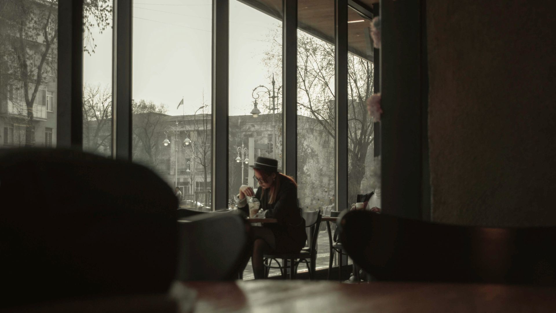 people sitting on chairs near window during daytime