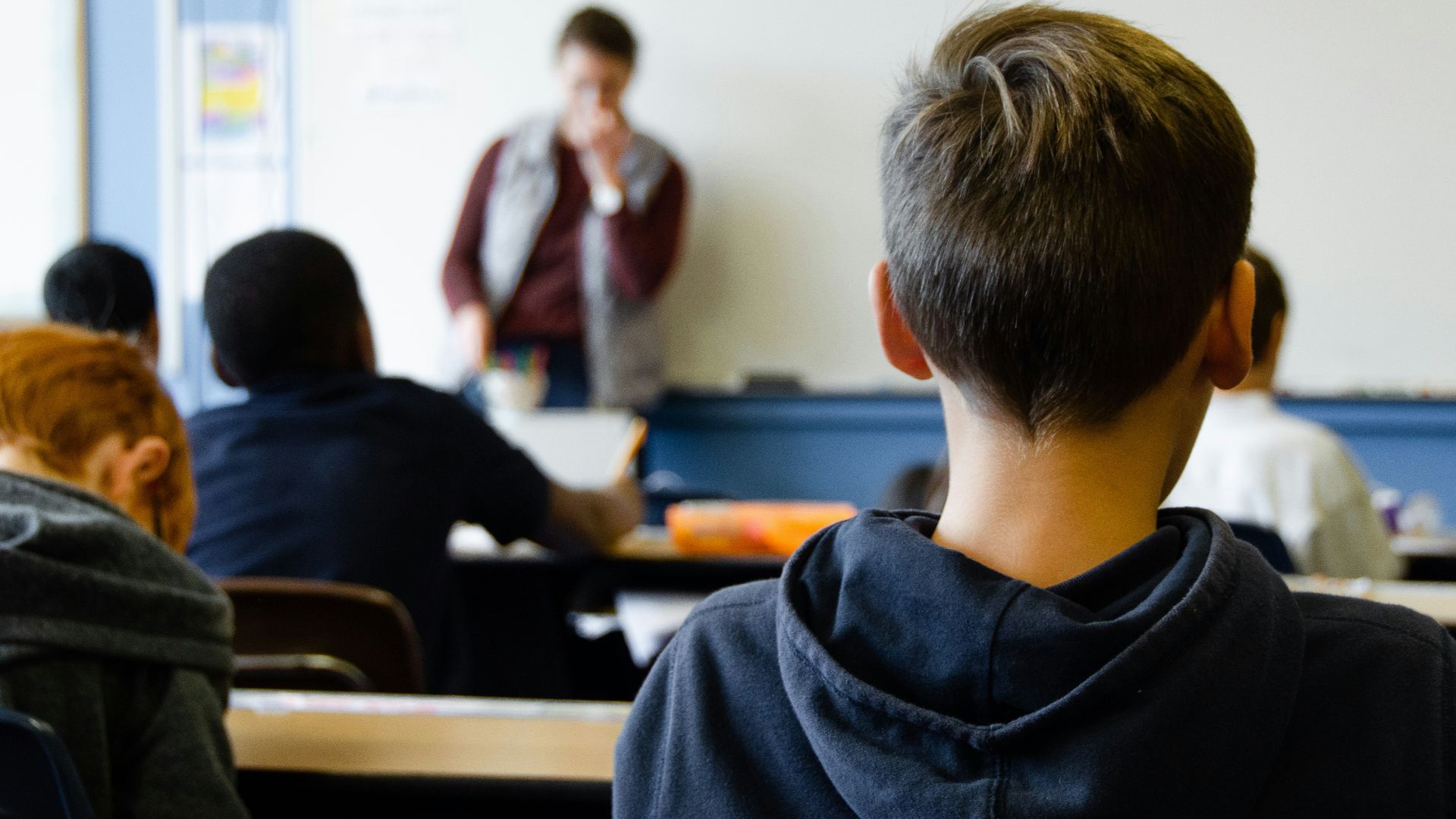 boy in black hoodie sitting on chair