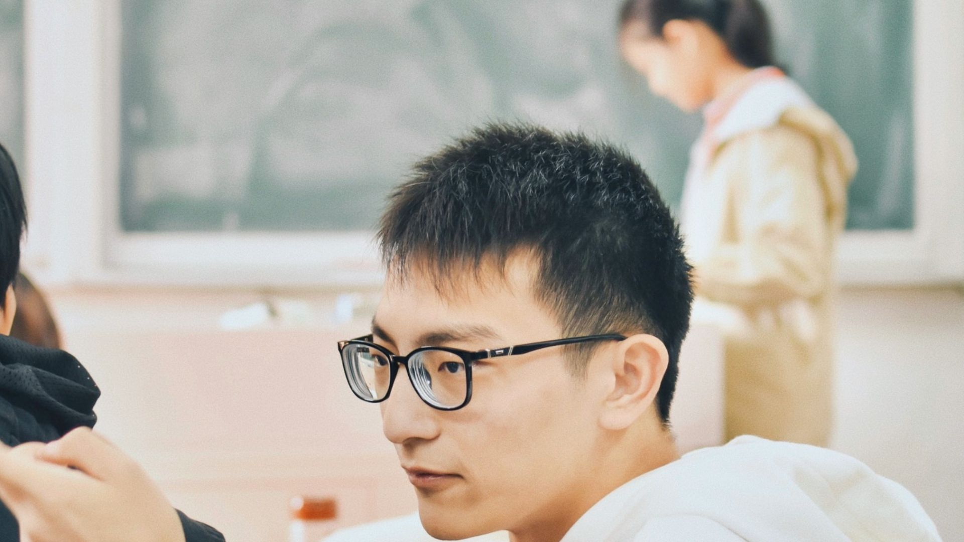 people sitting and standing inside classroom