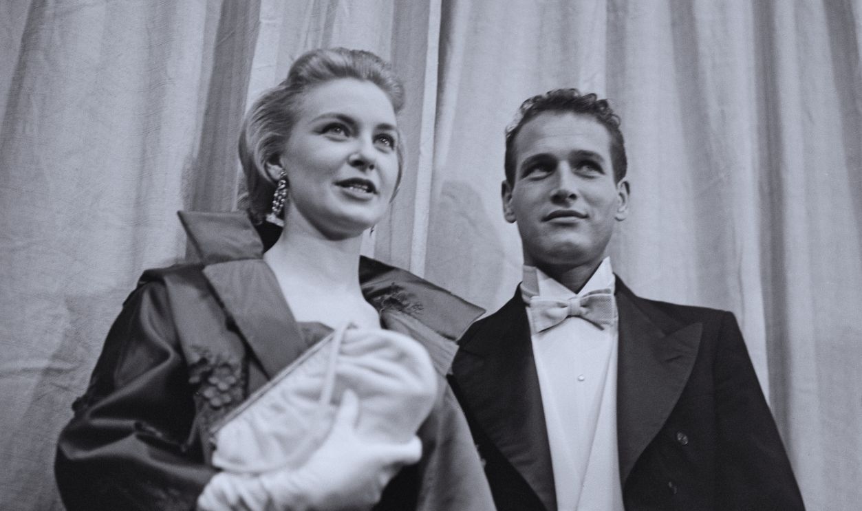 Gettyimages - 2148591393, 30th Academy Awards American actress Joanne Woodward, wearing a coat with white evening gloves, and a purse in her left hand, and her husband, American actor Paul Newman, who wears a tailcoat jacket and a white bow tie, attend the 30th Academy Awards, at the RKO Pantages Theatre in the Hollywood neighbourhood of Los Angeles, California, 26th March 1958. 