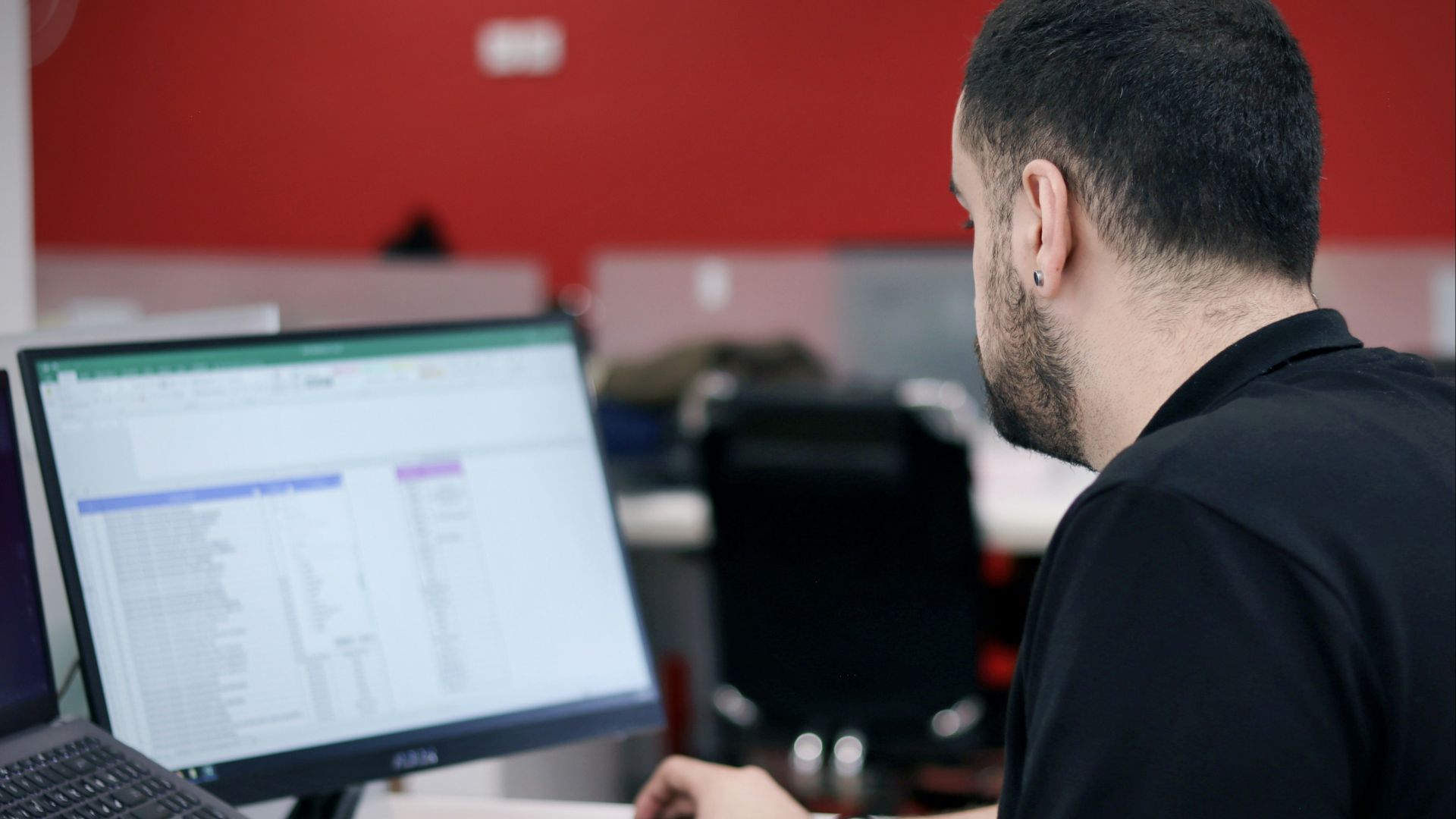 a man sitting in front of a laptop computer