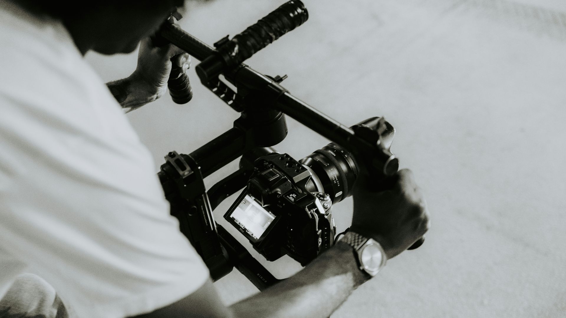 A person is holding a camera on a rig.