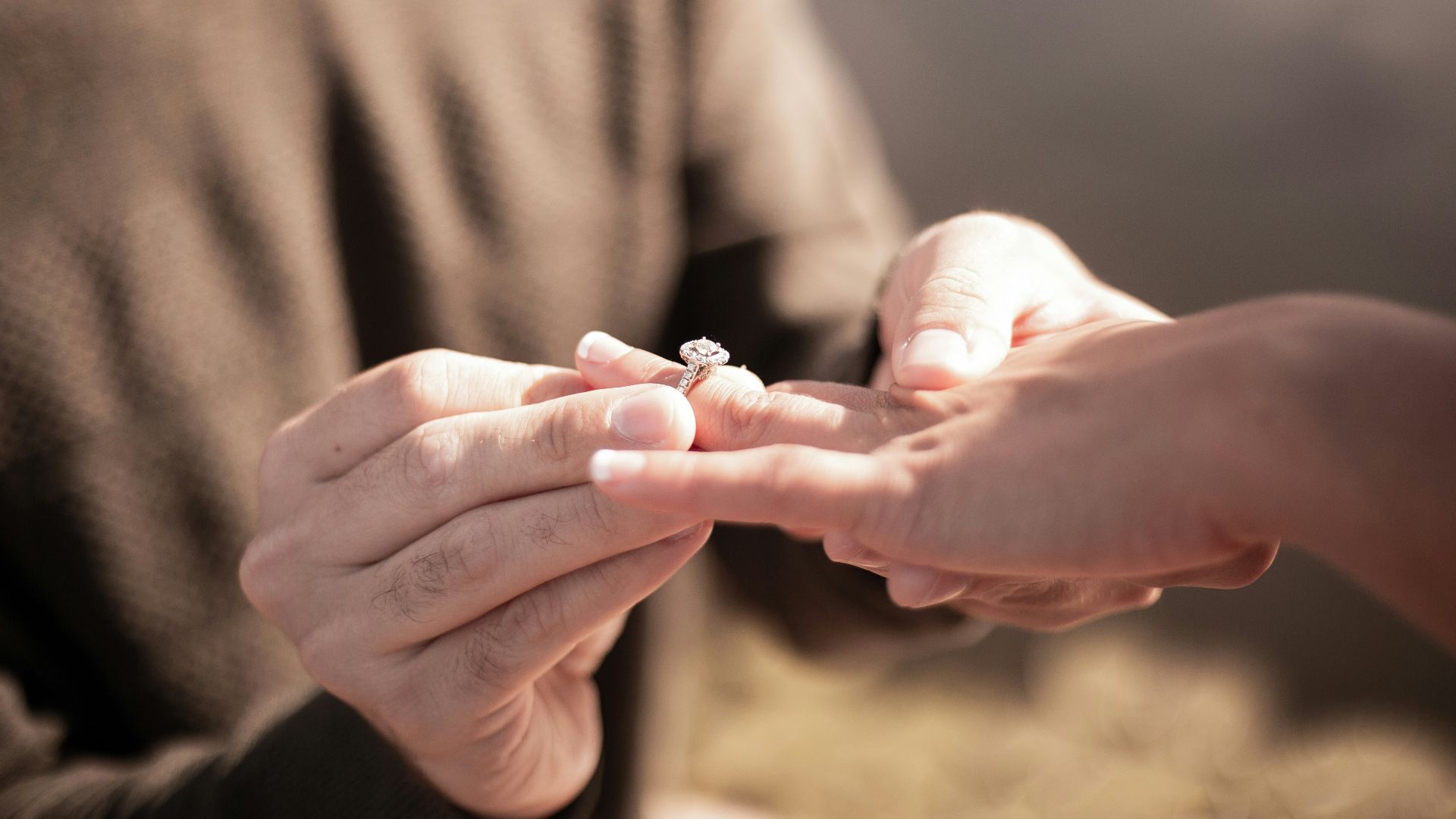 person holding silver diamond ring