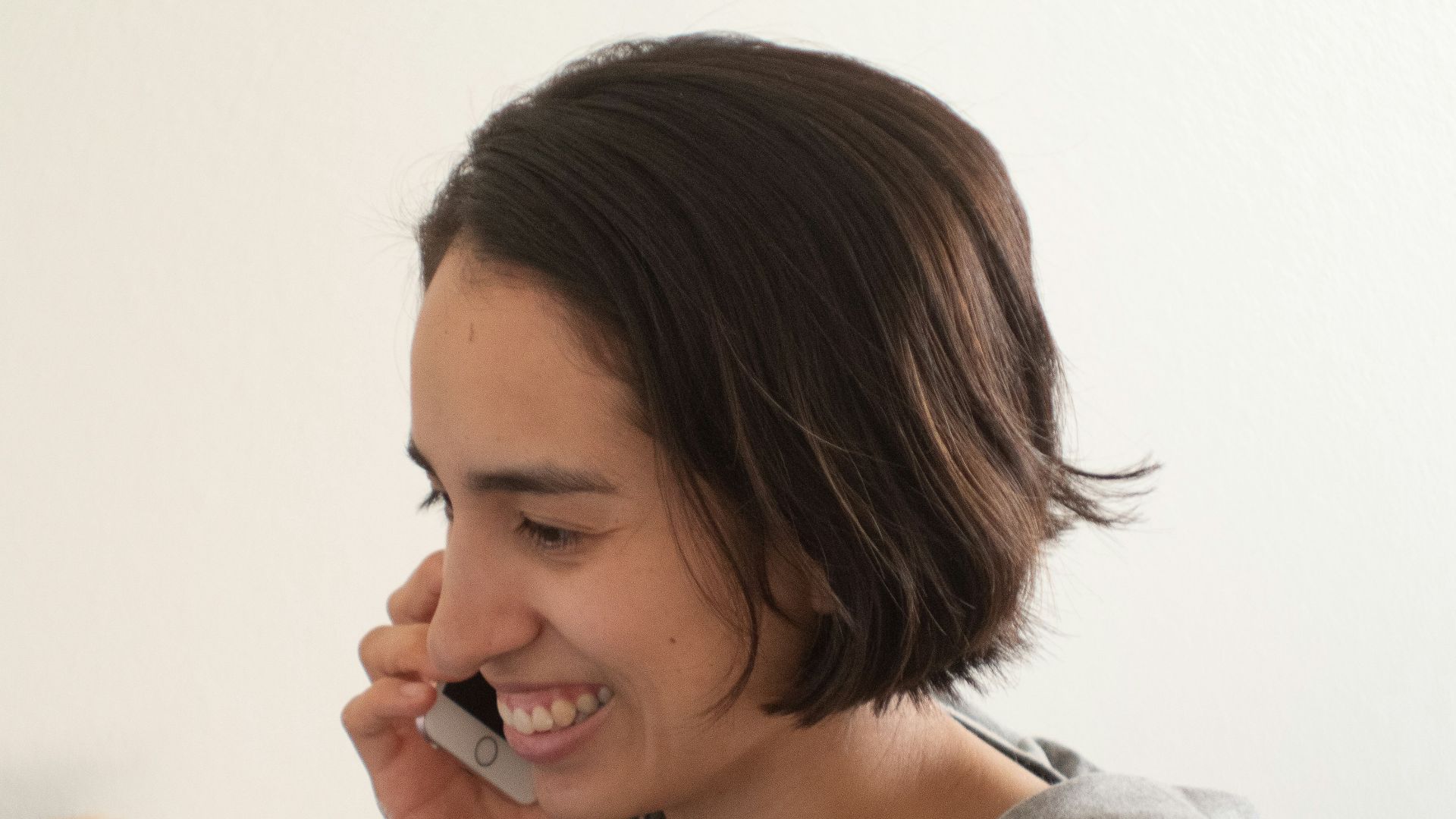 woman in gray hoodie smiling