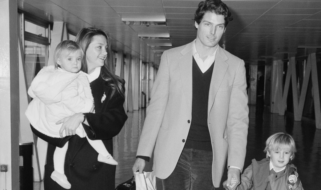 American actor Christopher Reeve (1952 - 2004) with his partner Gae Exton and their children Matthew Reeve and Alexandra Reeve Givens at Heathrow Airport, London, UK, 23rd January 1984.