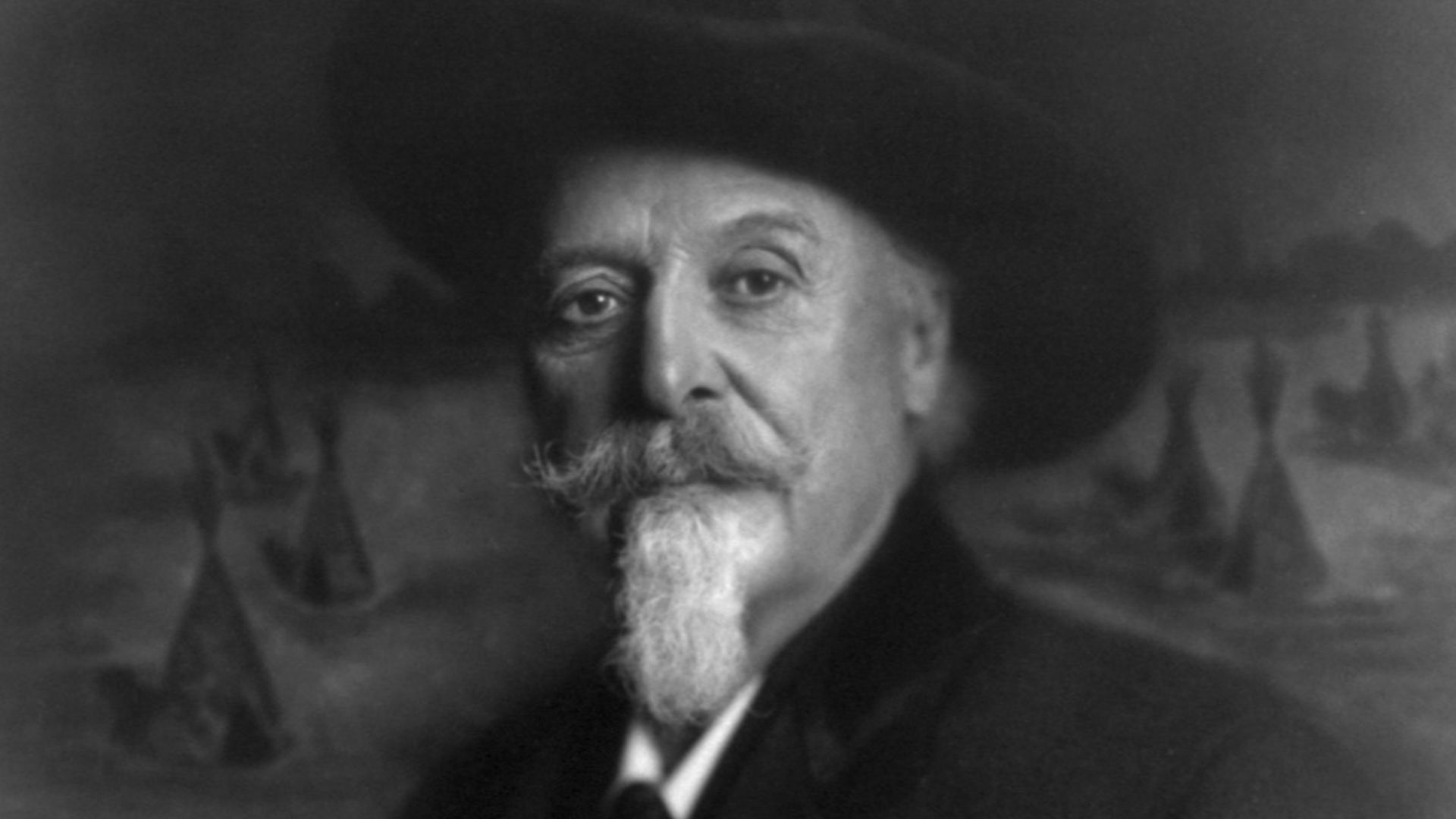 File:William Frederick Cody, 1846-1917, half-length portrait, facing left, in front of picture with teepees LCCN2005679789.jpg