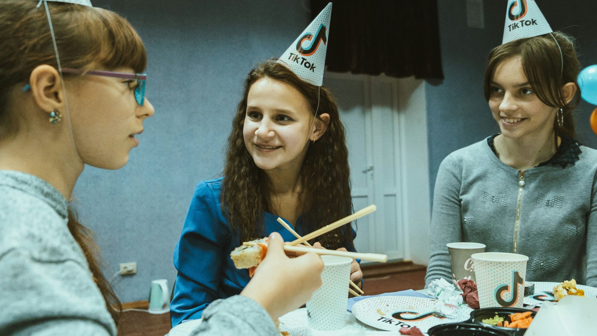 a group of young women sitting around a table