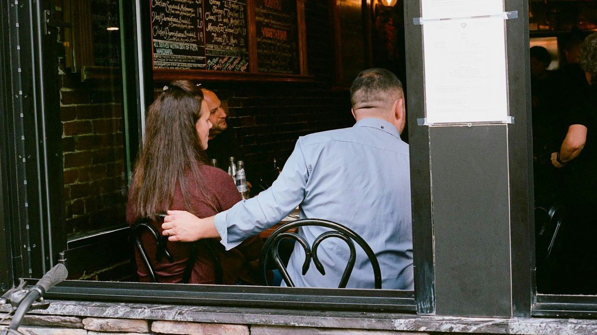 A man and a woman sitting at a table in a restaurant