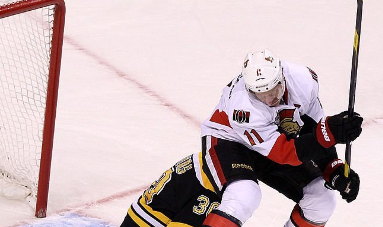 BOSTON - FEBRUARY 28: Ottawa Senators right wing Daniel Alfredsson (#11) timed his jump perfectly screening Boston Bruins goalie Tim Thomas (#30) on a power play goal during the first period. Boston Bruins took on the Ottawa Senators at TD Garden