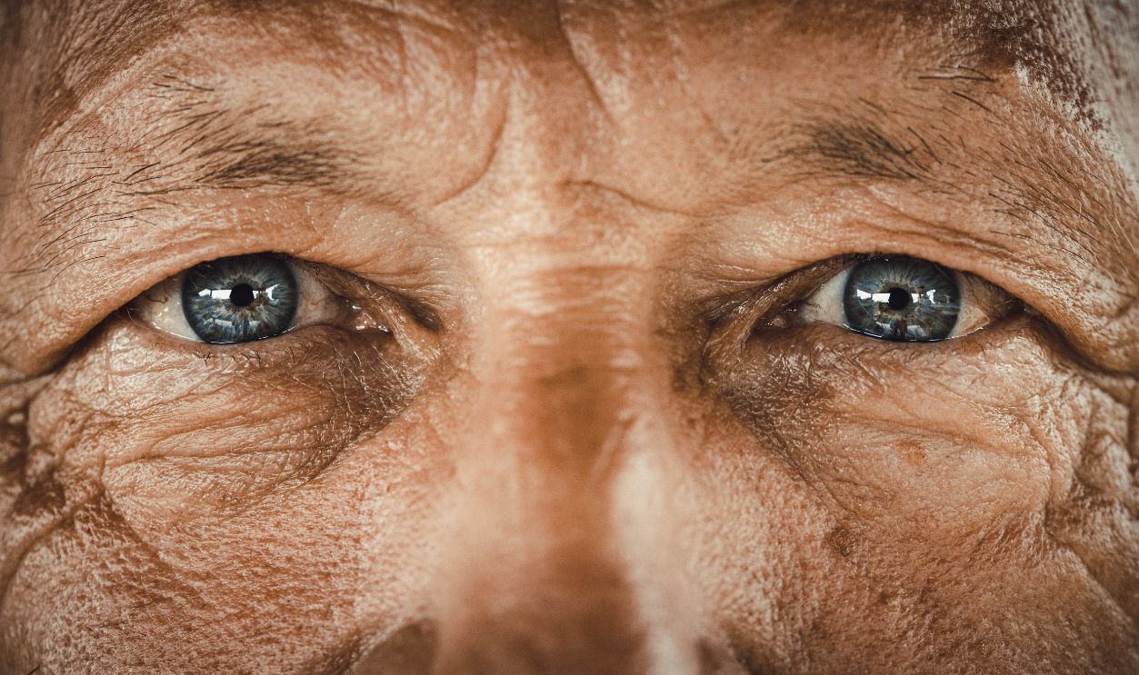 Blue-eyed senior man. - stock photo Close up of senior man's blue eyes looking at camera.