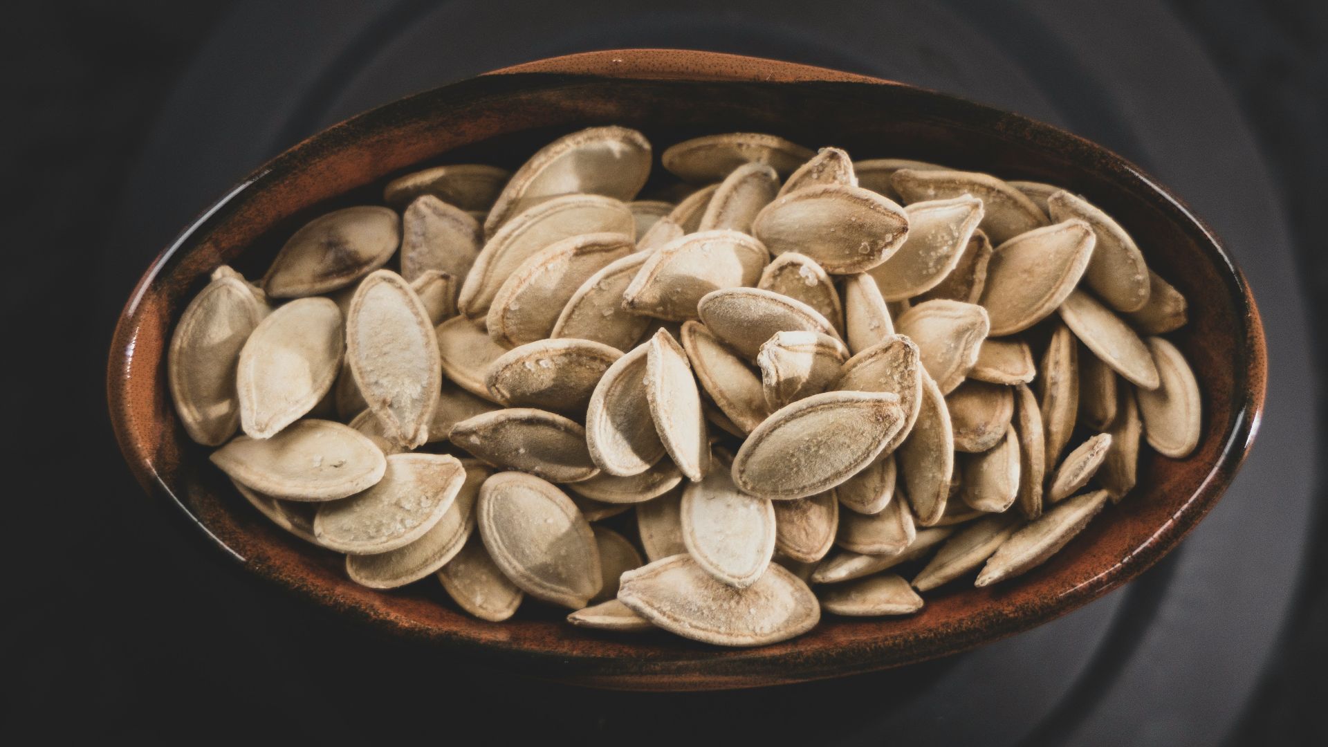 brown and white nuts on brown ceramic bowl