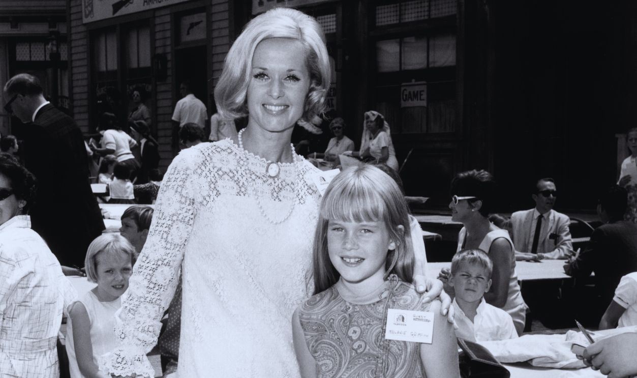 Gettyimages - 3226706, Melanie's Mum August 1966: American actor Tippi Hedren and her daughter, Melanie Griffith, at a children's party, a 'Batman' luncheon for an orphanage in California. 