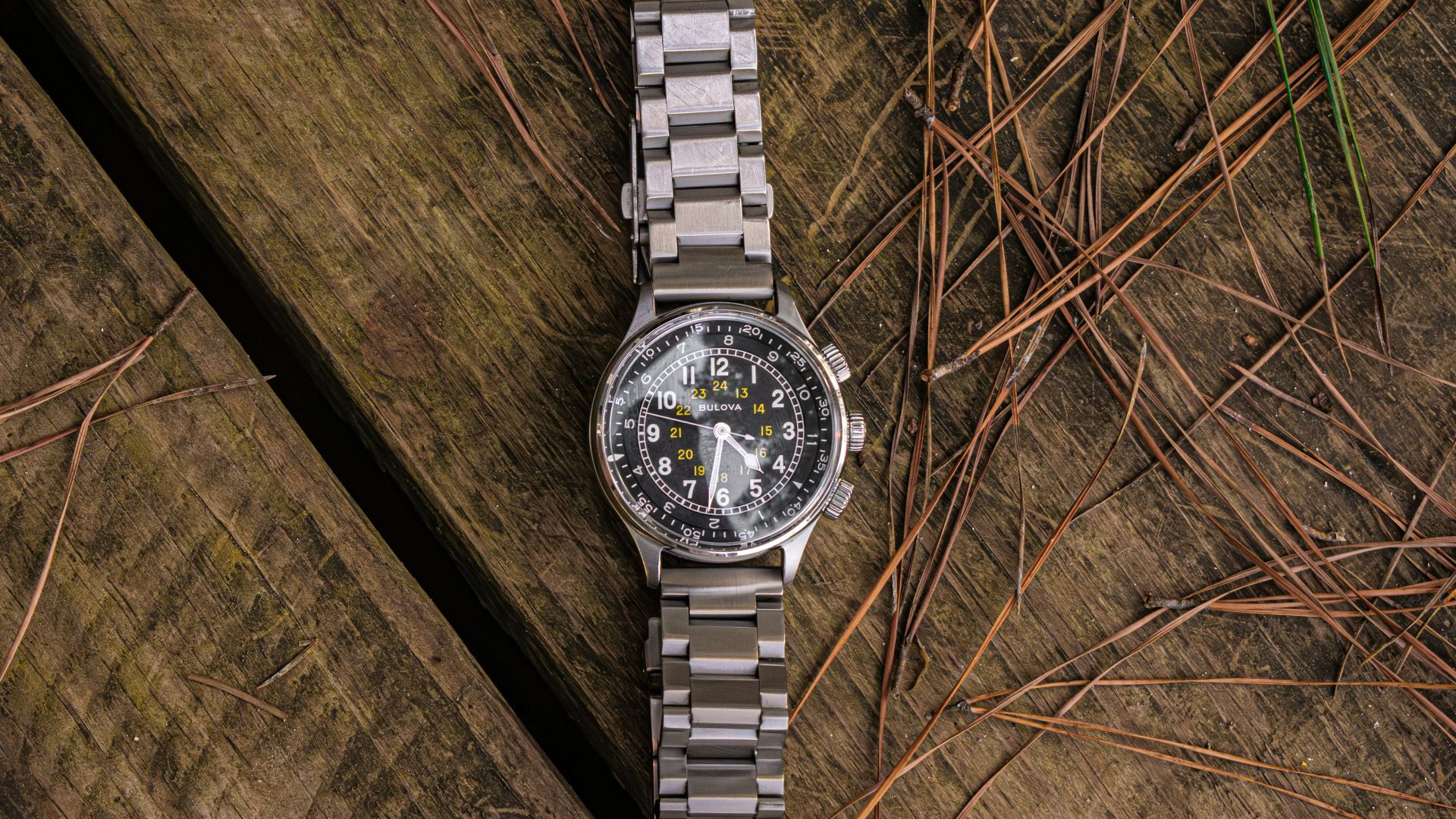 A watch sitting on top of a wooden table