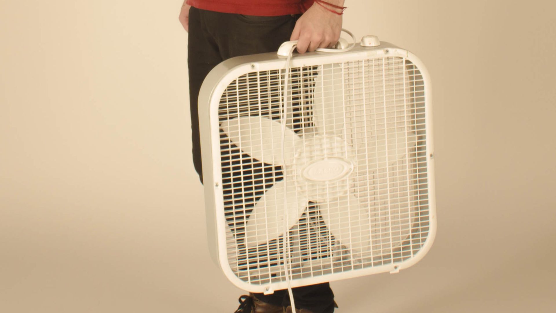 File:Young man carrying a box fan.jpg