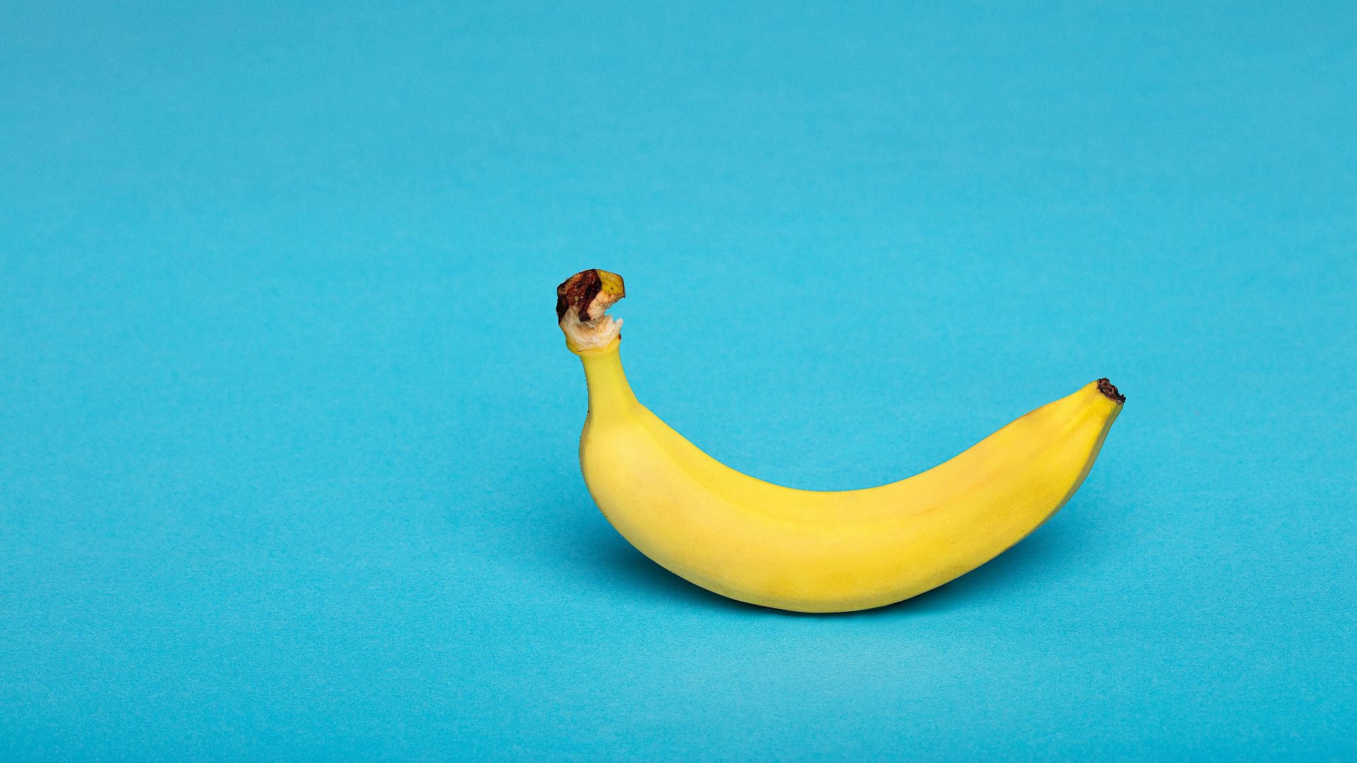 yellow banana fruit on blue surface
