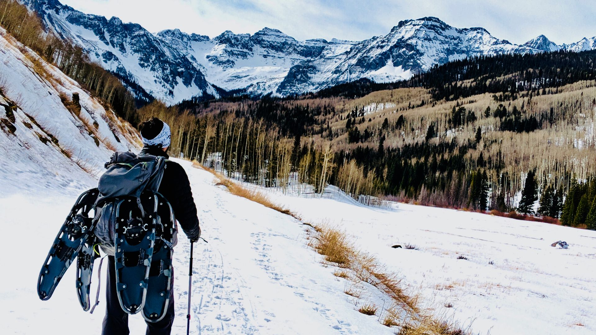 man wearing backpack on snow