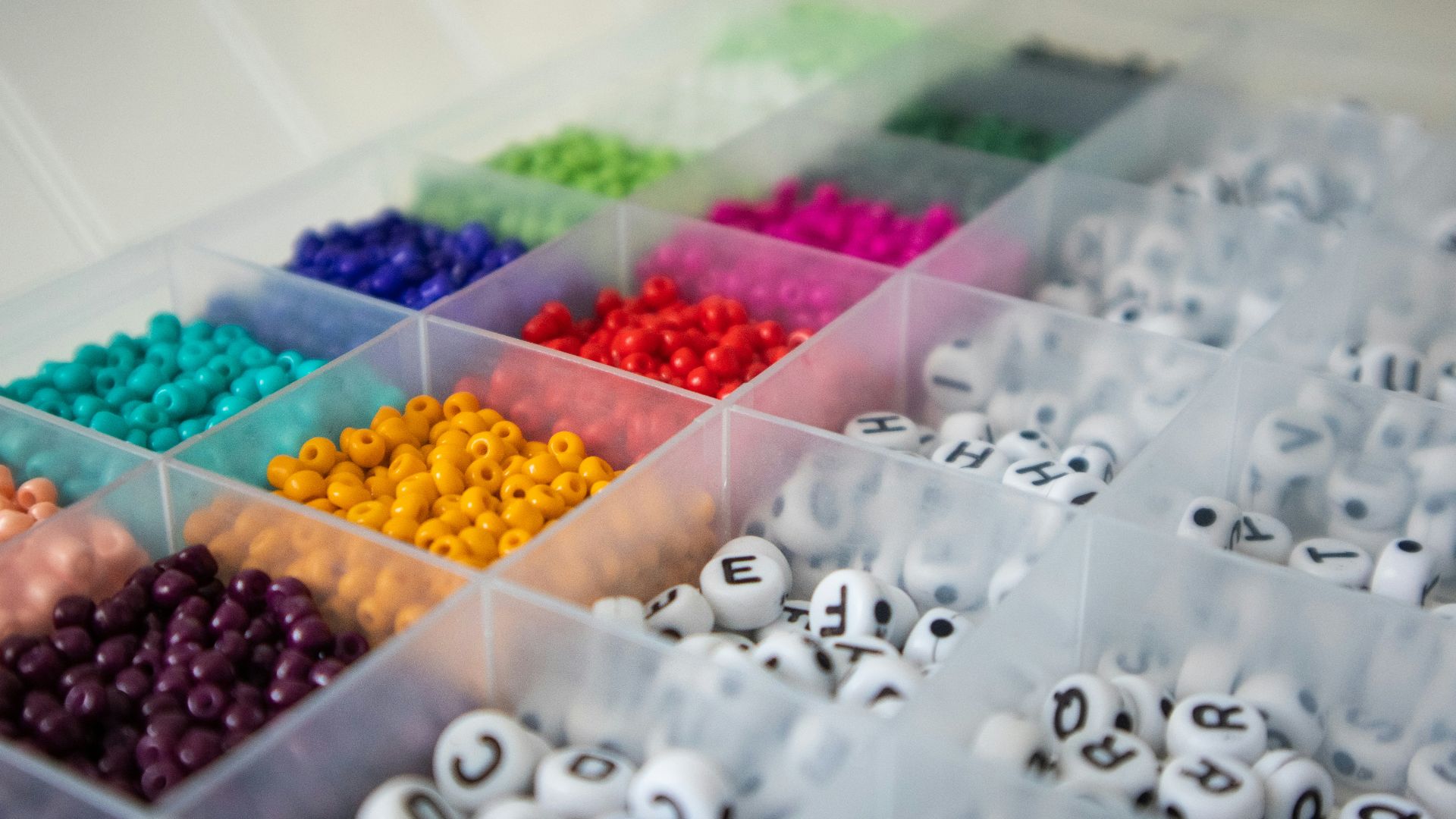 a box filled with lots of different colored beads