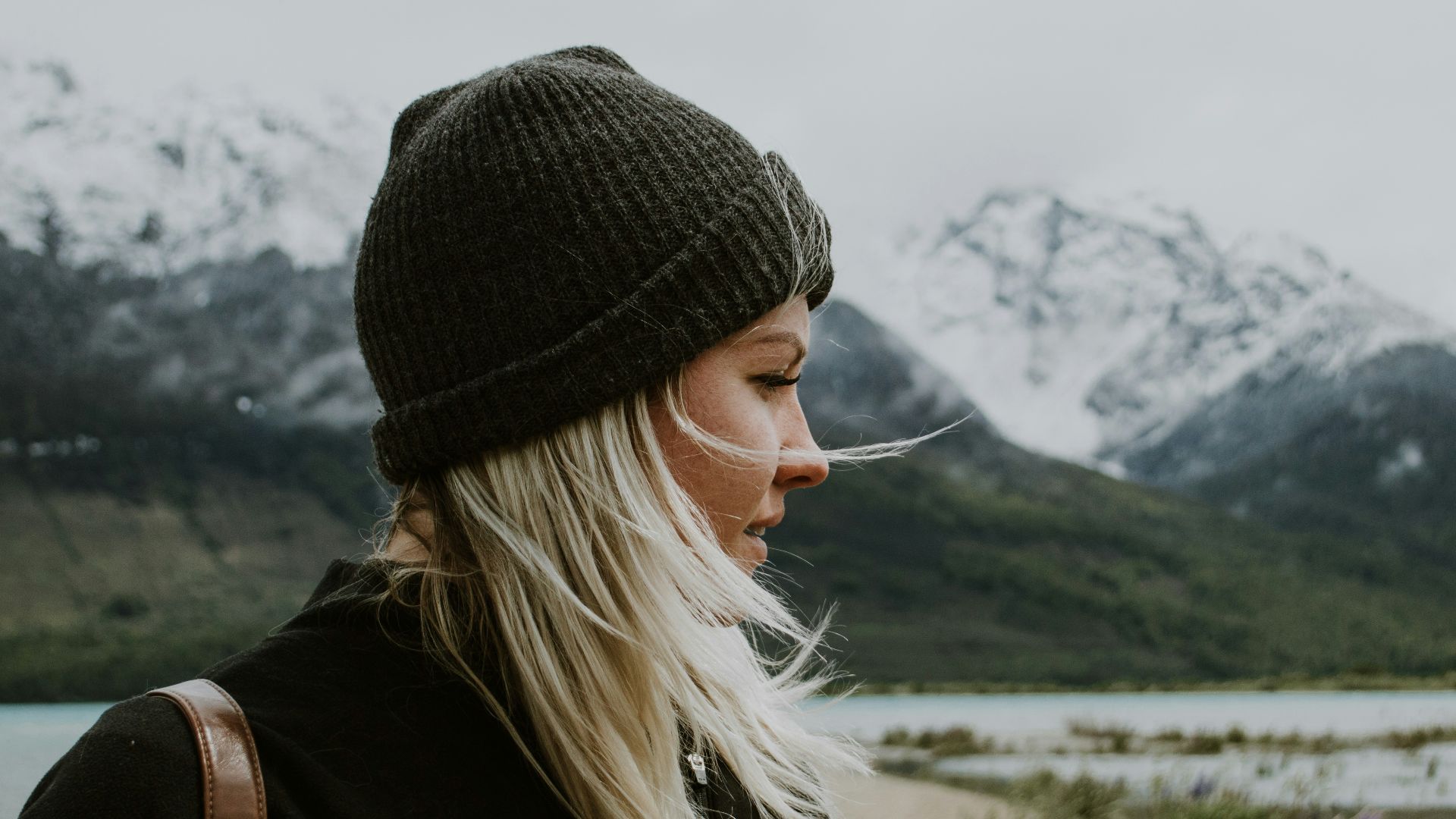 woman in black knit cap and black jacket