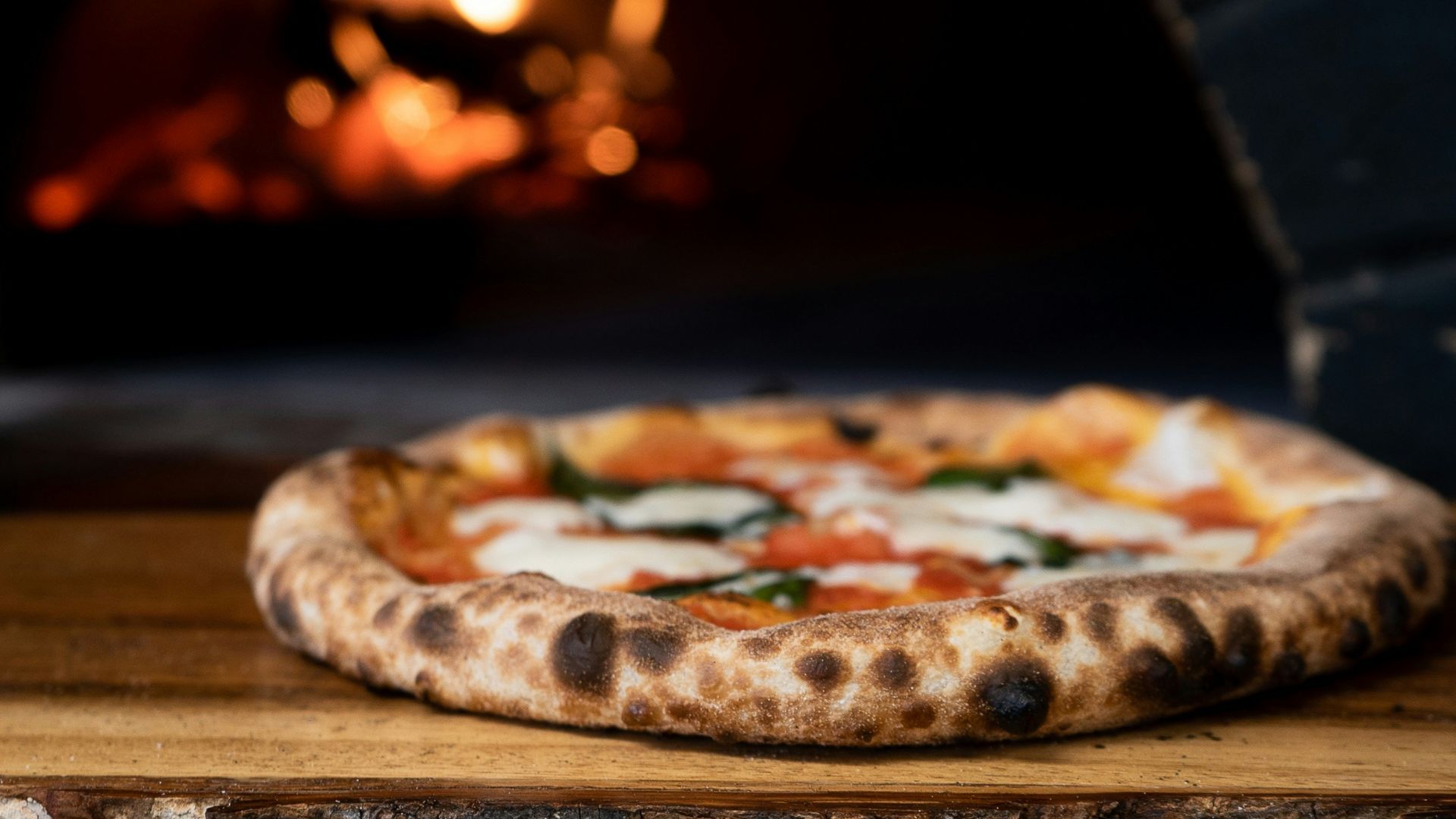 pizza on brown wooden table