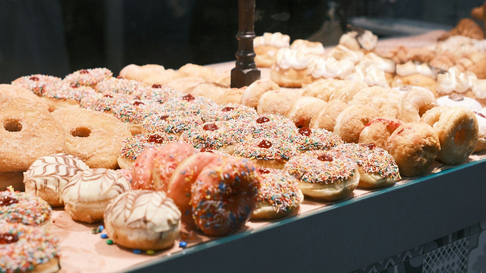 a display case filled with lots of different types of donuts