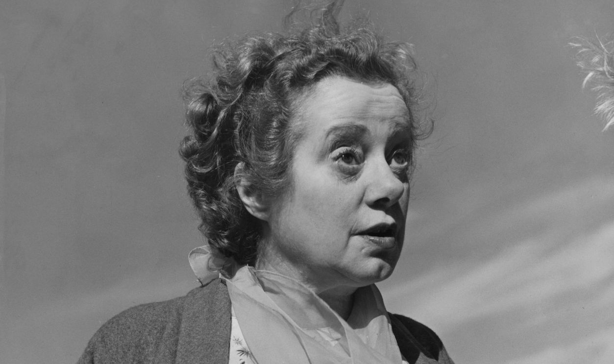 Actress Elsa Lanchester (1902 - 1986) autographs a ball after a softball match between members of the Stratford Memorial Theatre and officers of the United States Air Force Base at Fairford, Gloucestershire, June 1959. The Fairford Layabouts beat the actors 7-6 at the base. 