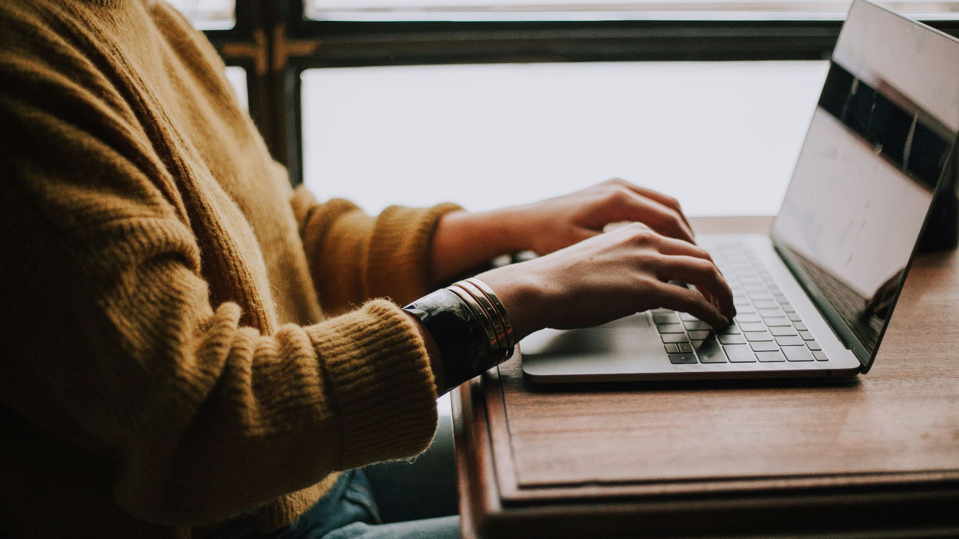 person sitting front of laptop
