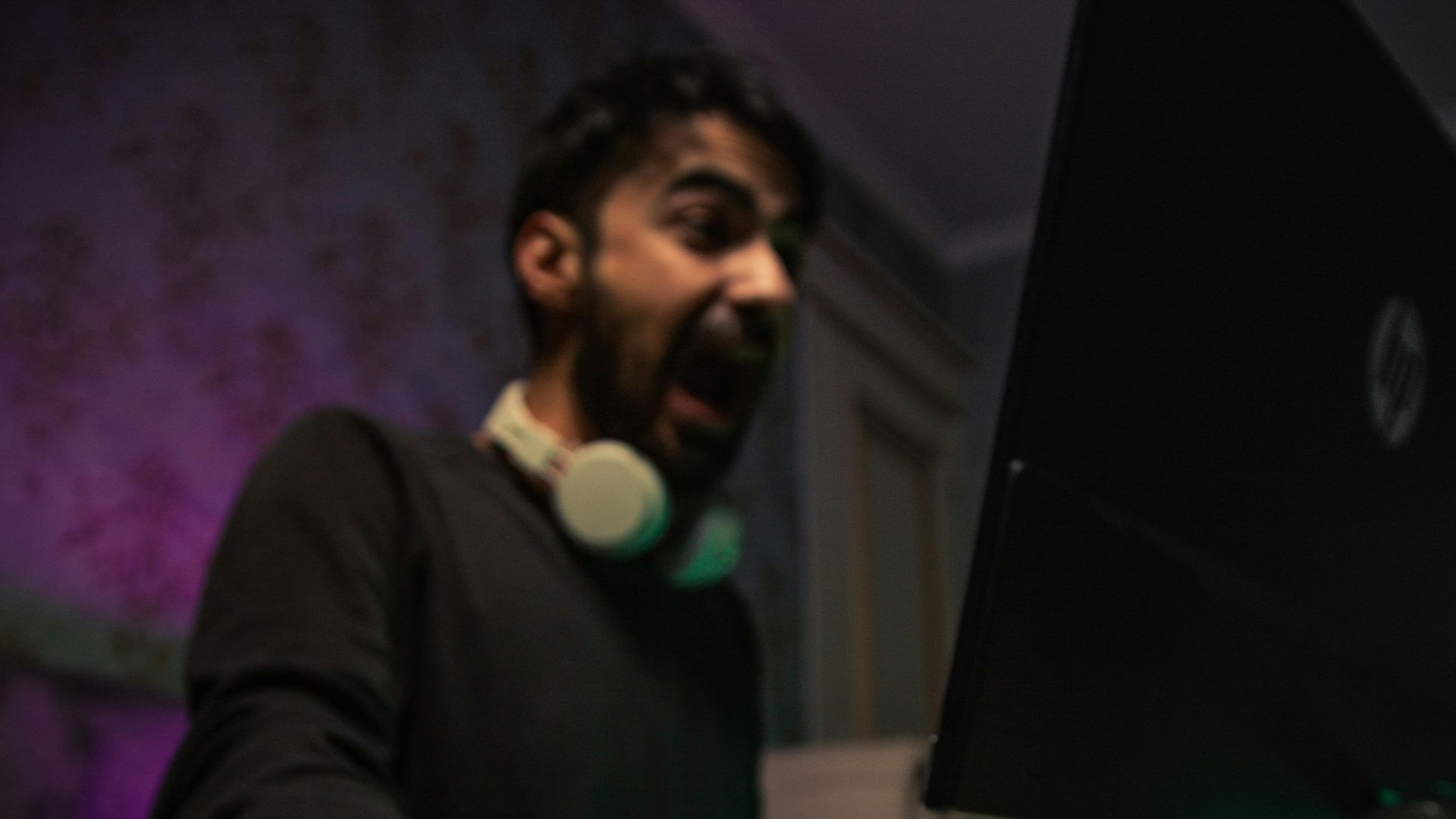 man in black long sleeve shirt holding black laptop computer