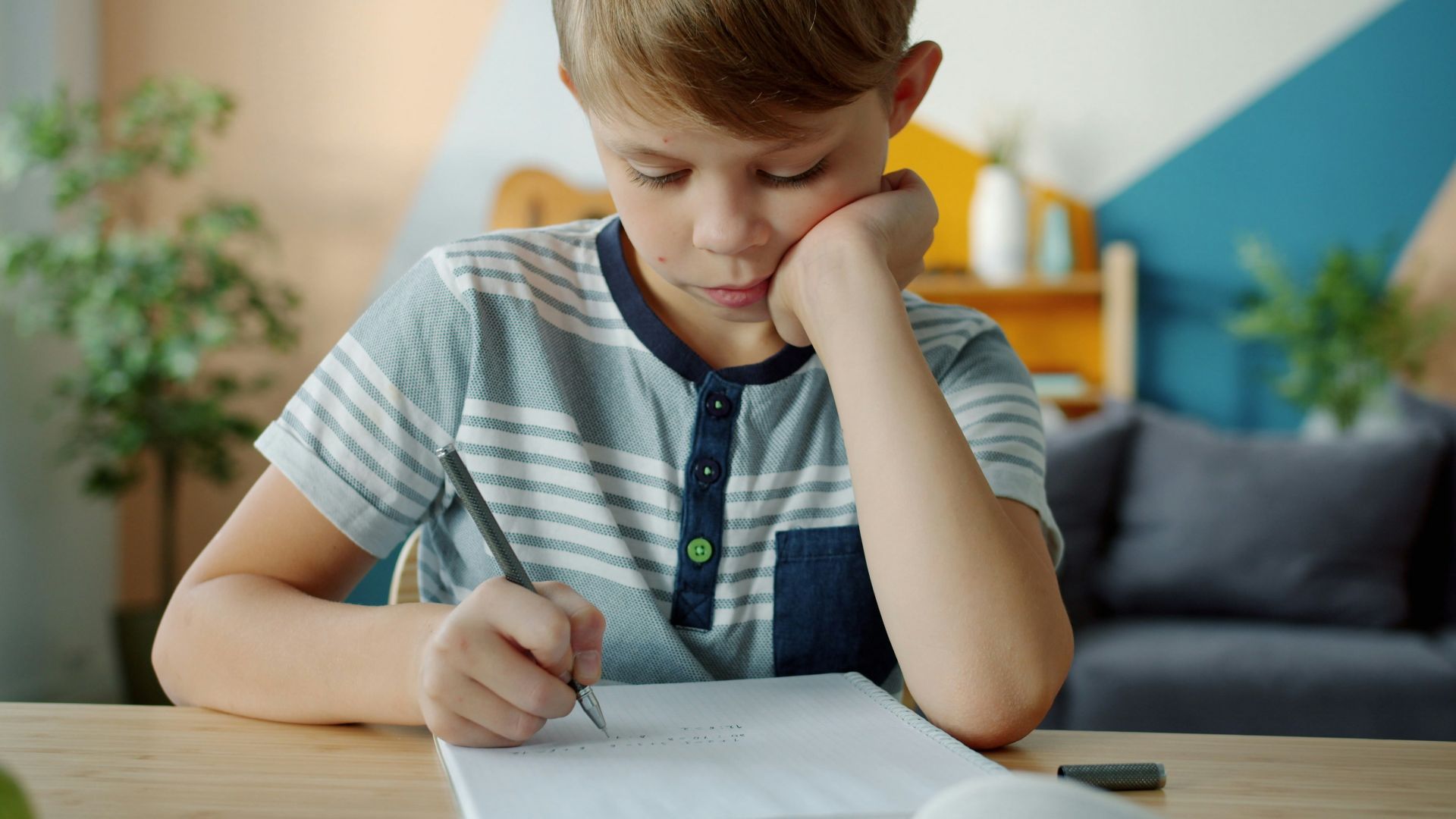 Young boy doing homework at a desk