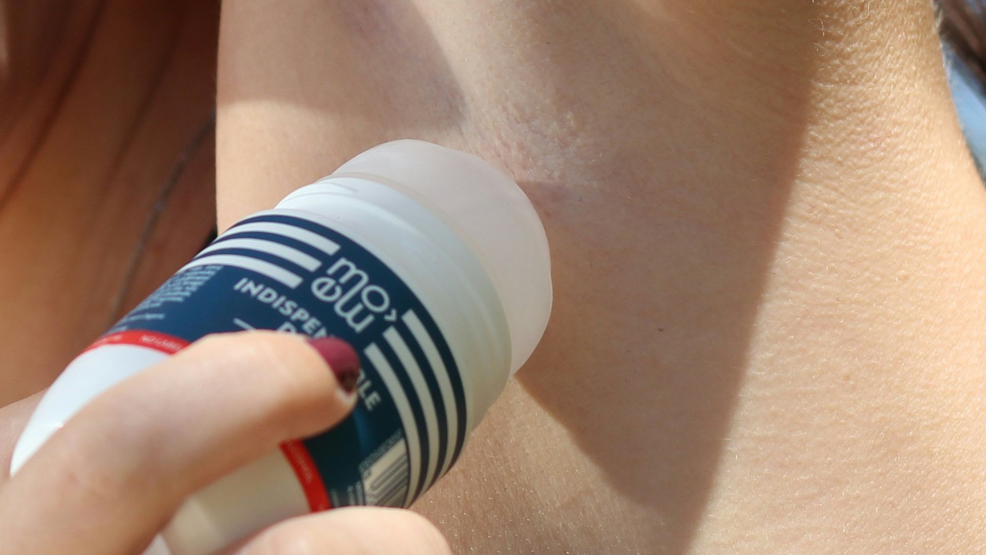 woman holding blue and white bottle