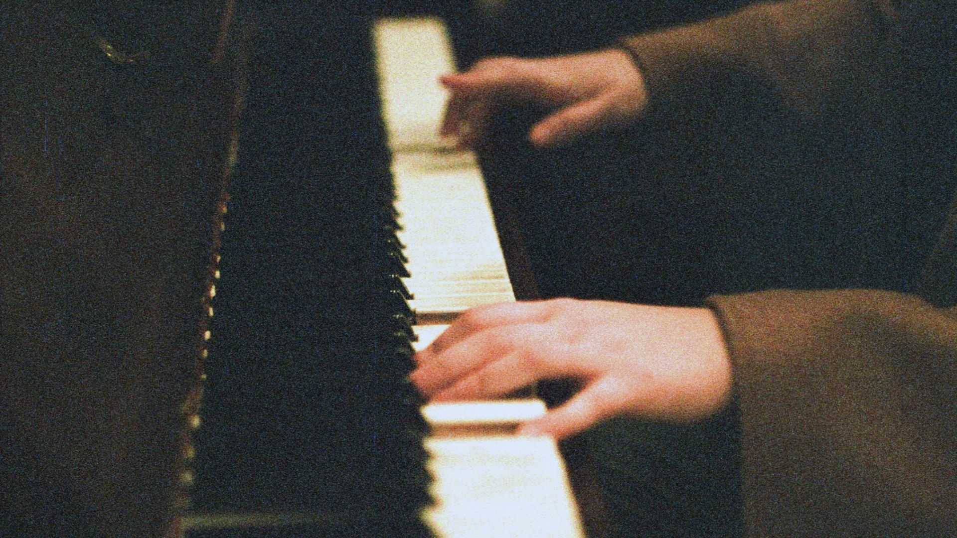 person about to play white and black piano