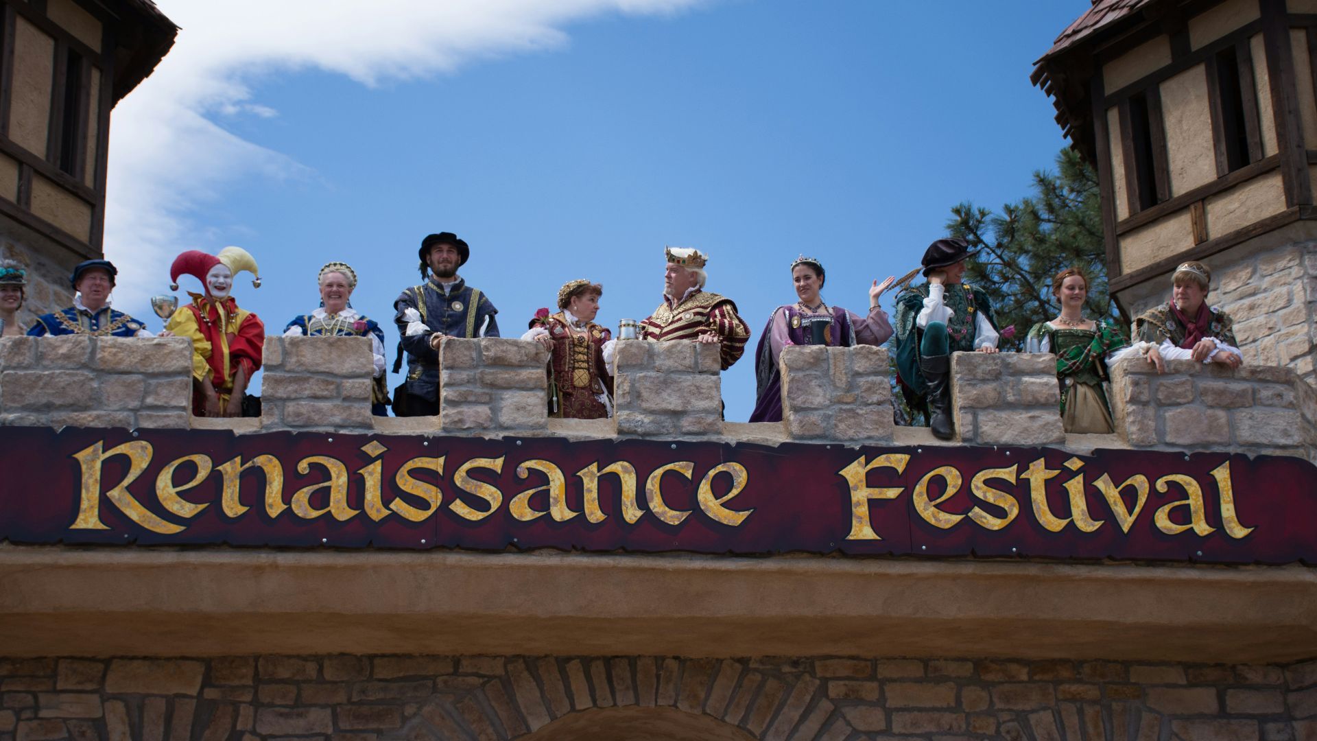 a group of people standing on top of a stone wall