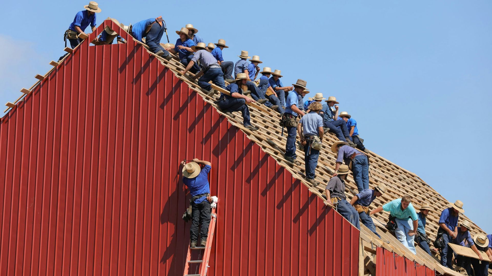group of construction workers constructing house