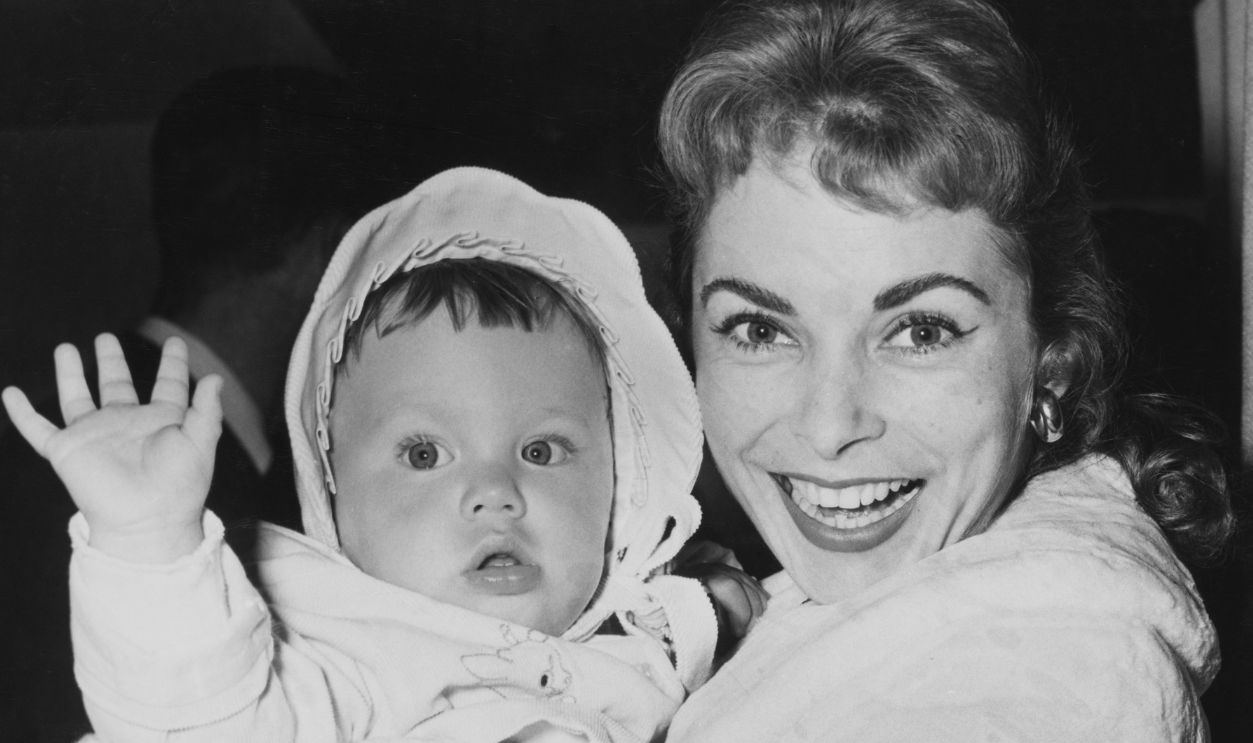 Gettyimages - 1435960119, Janet Leigh With Daughter Jamie Lee Curtis Janet Leigh smiles holding her baby daughter Jamie Lee Curtis in her arms, United States, circa 1959.