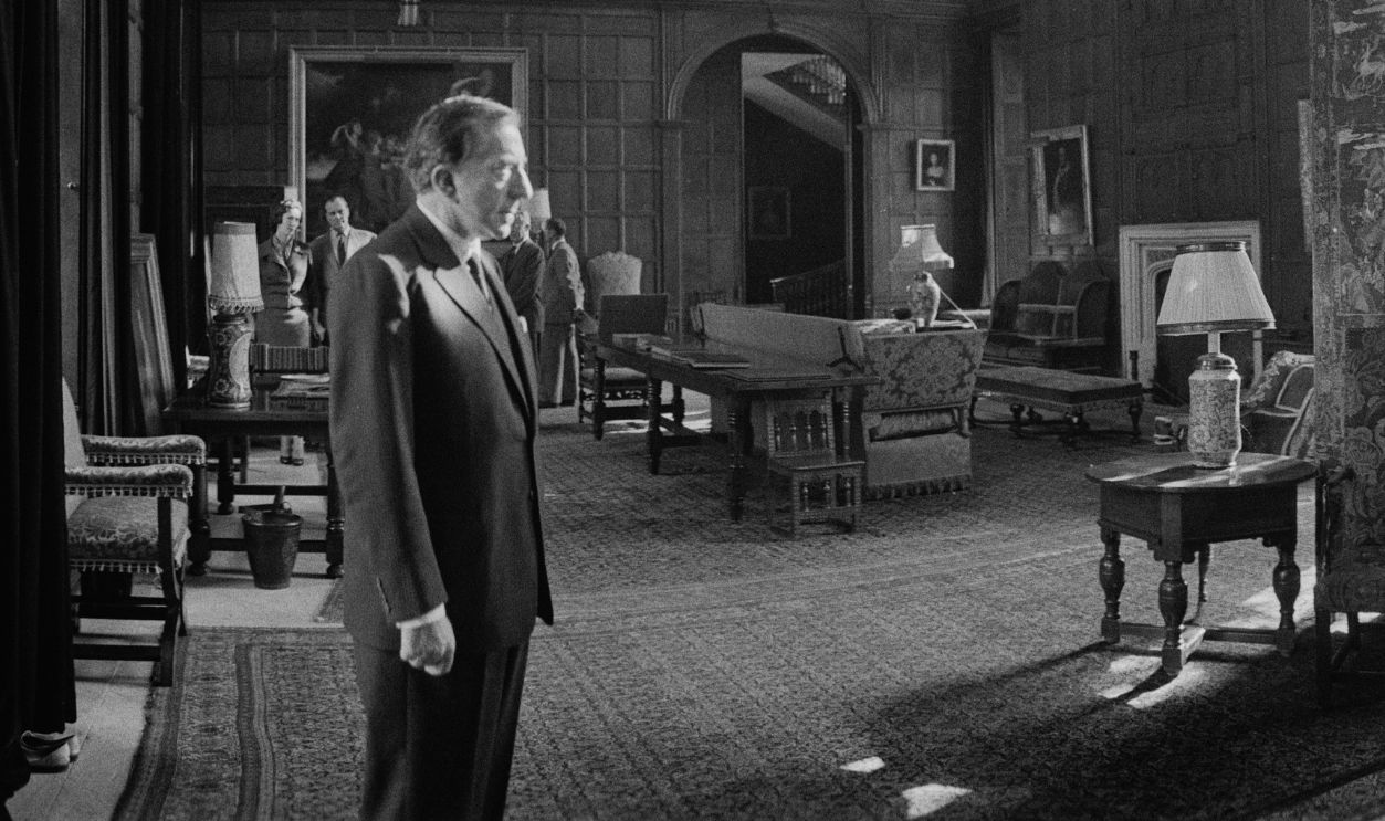 A wide angle view of businessman Jean Paul Getty standing in a hall in his mansion Sutton Place, Woking, Surrey, October 17th 1959. 