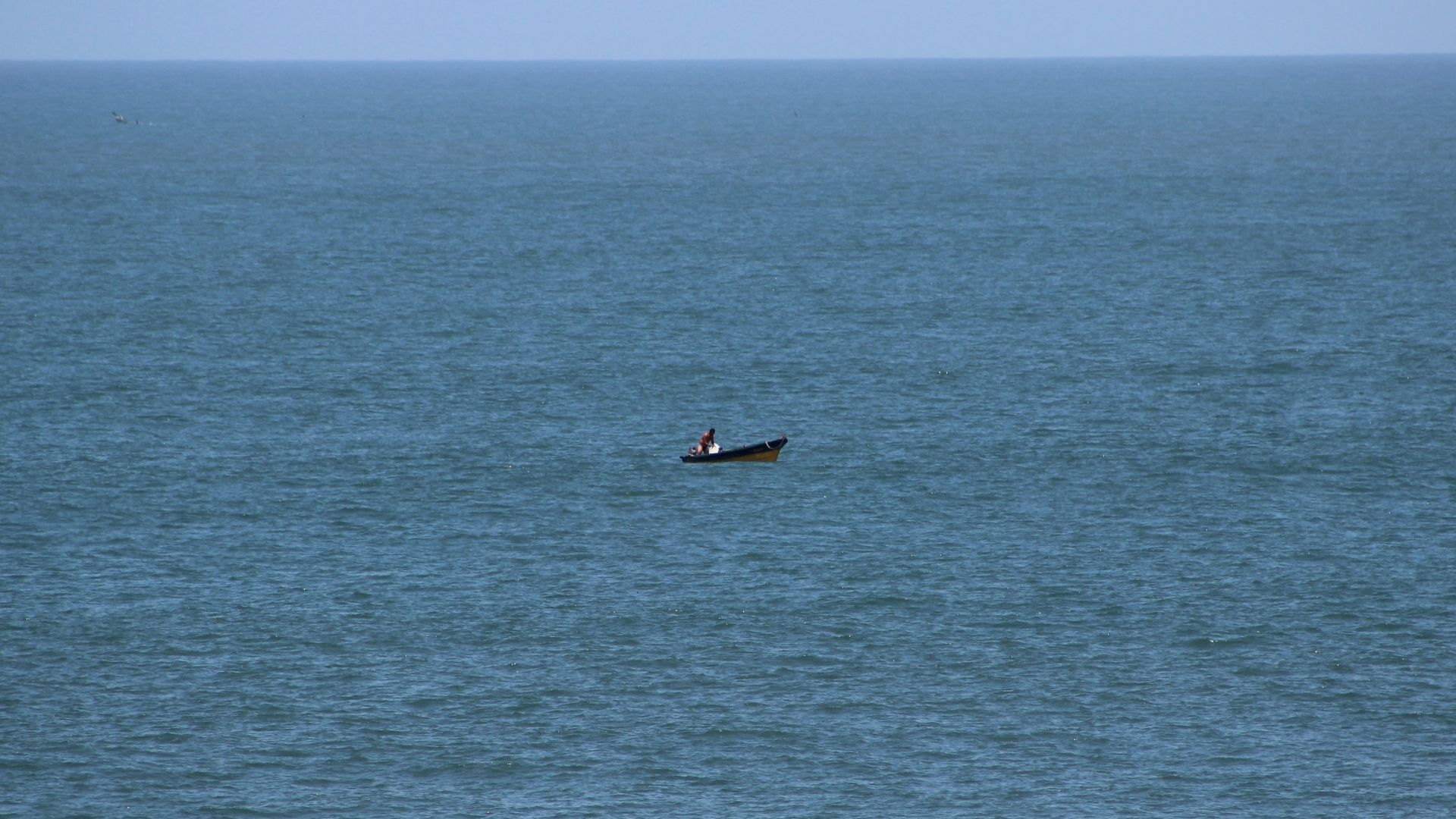 person riding on boat on sea during daytime