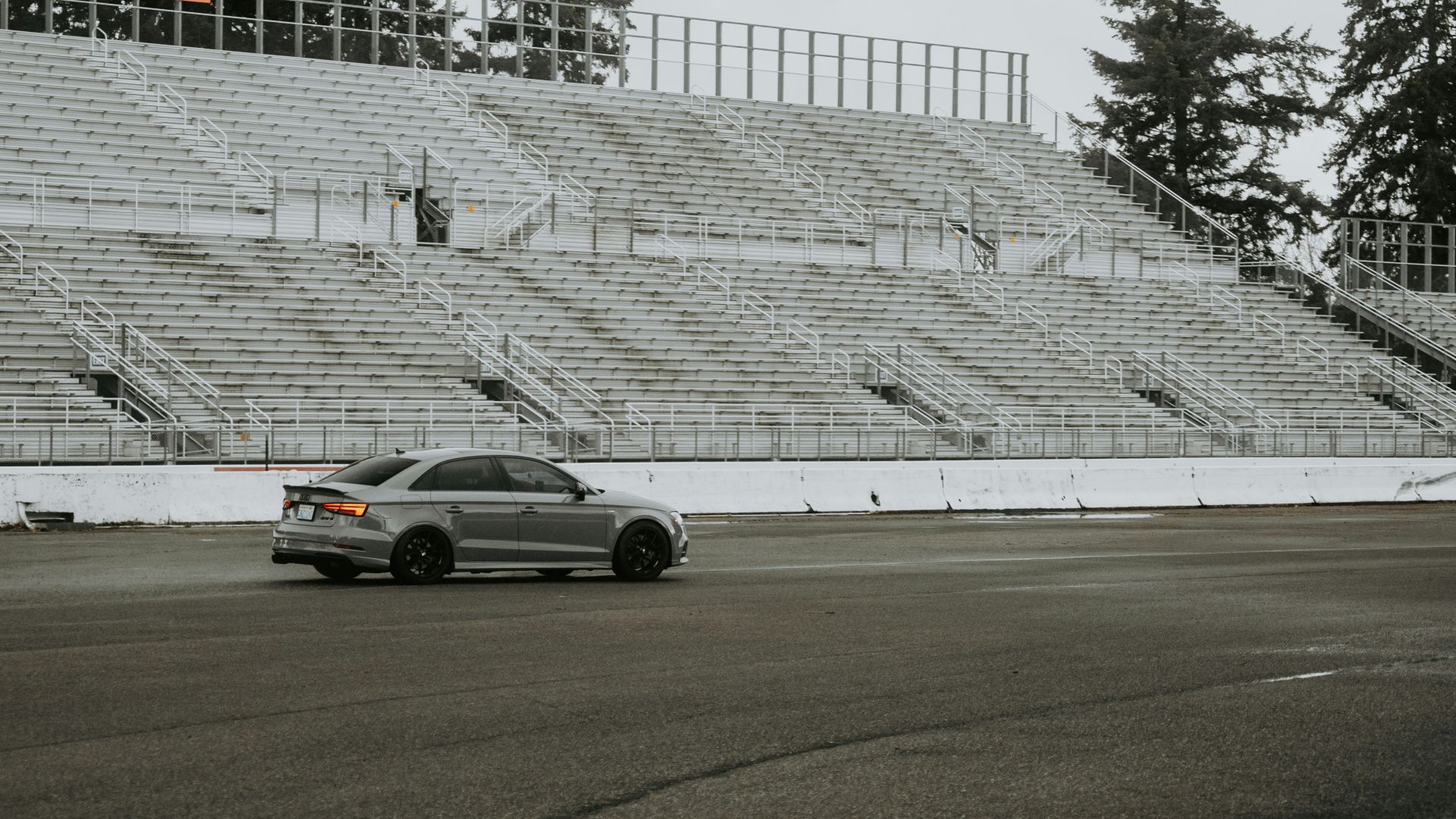A car drives around an empty racetrack.