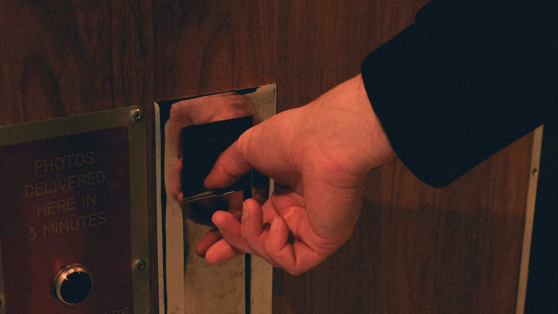 a person opening a door with their hand