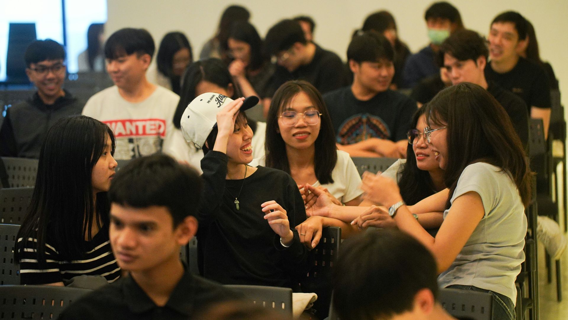 A group of young people sitting in chairs