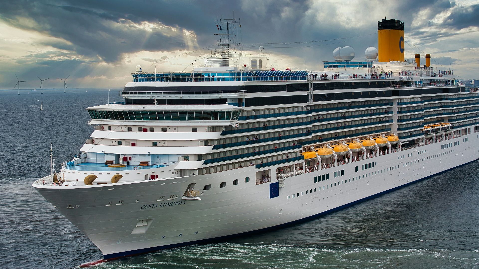 white cruise ship on sea under white clouds and blue sky during daytime