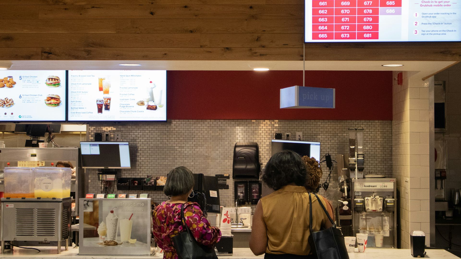 a couple of women standing in front of a counter