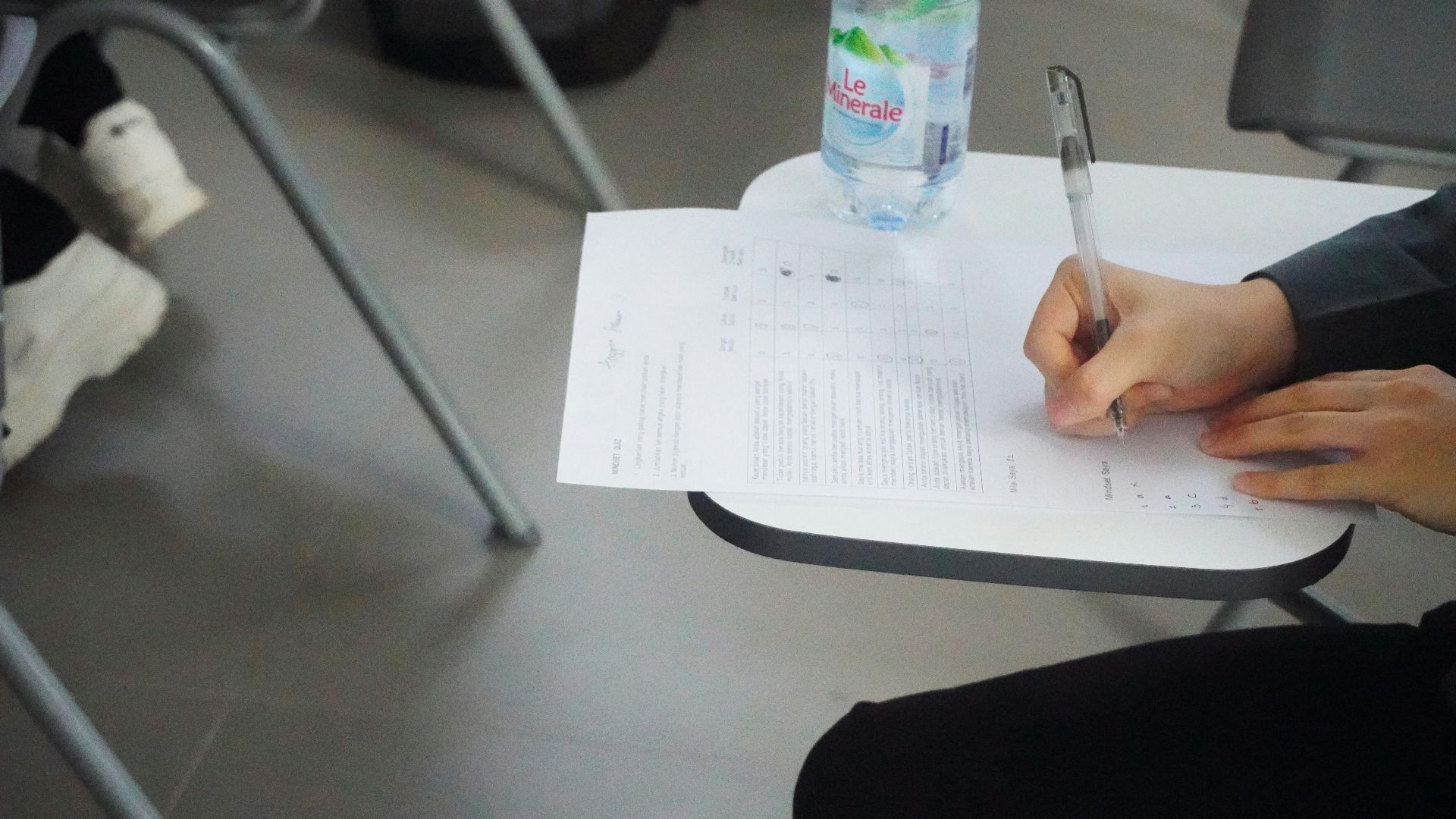 a person writing on a piece of paper