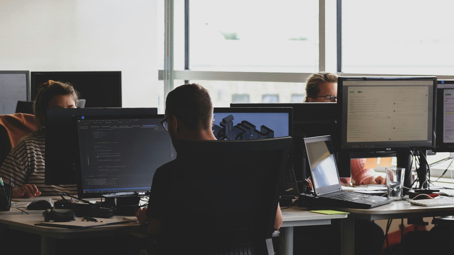 people sitting on chair in front of computer monitor