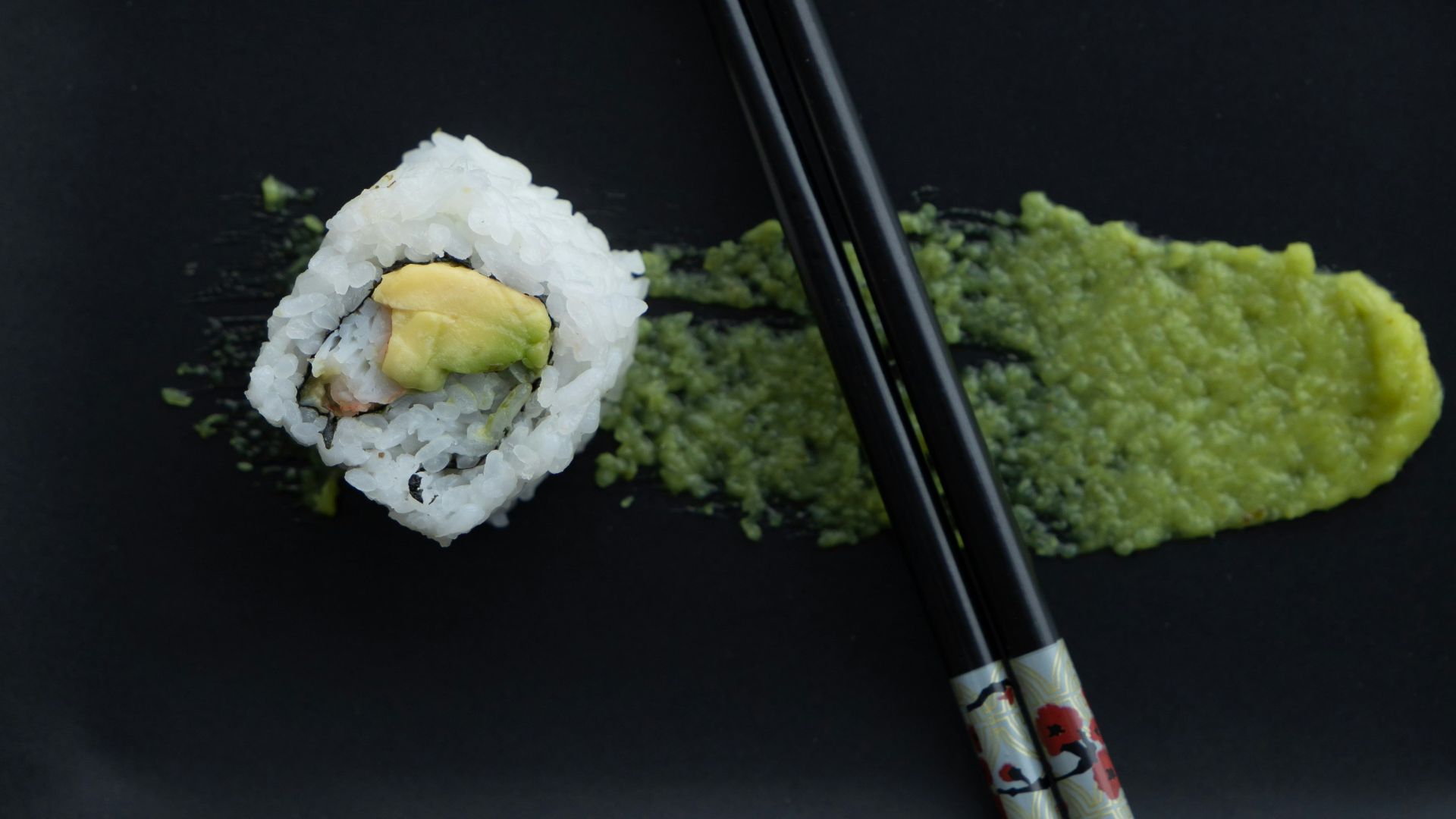 white and green sushi on black table