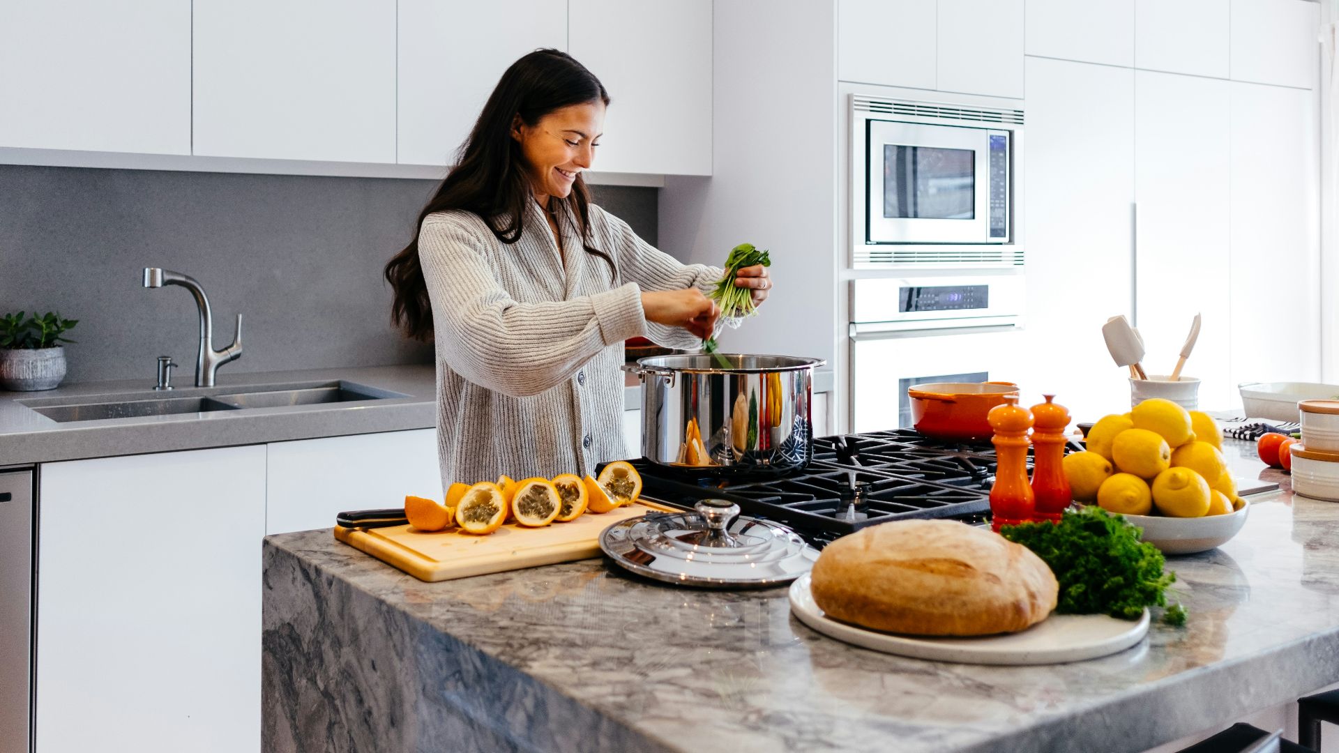 woman smiling while cooking