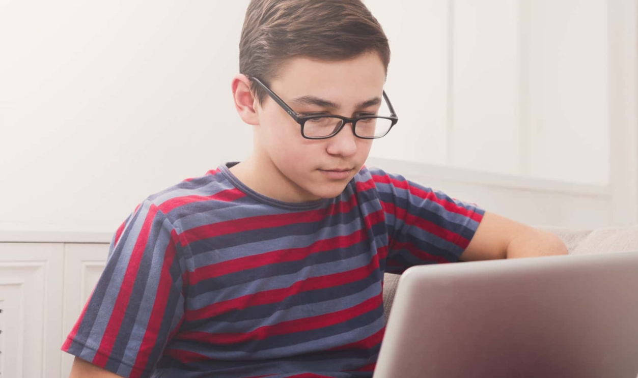 Teenager With Computer  - Shutterstock 656135953