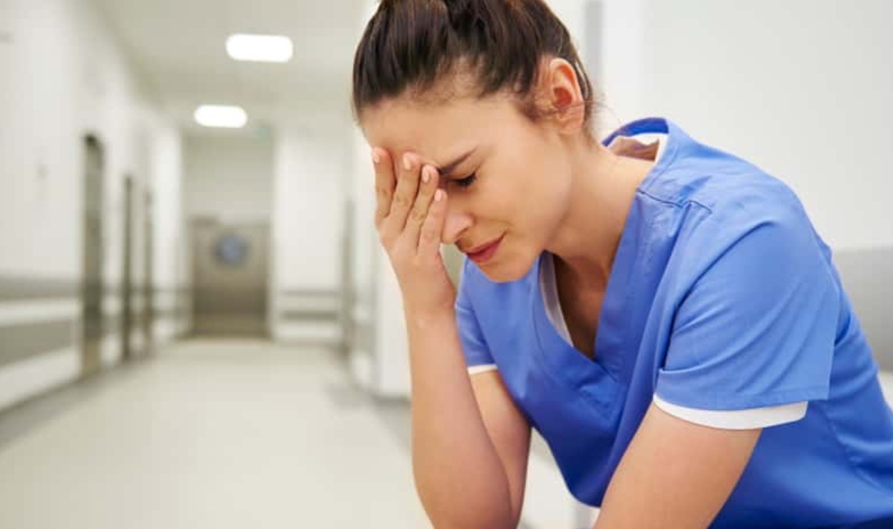 Female Nurse Suffering From Headache, Shutterstock, 1369626374