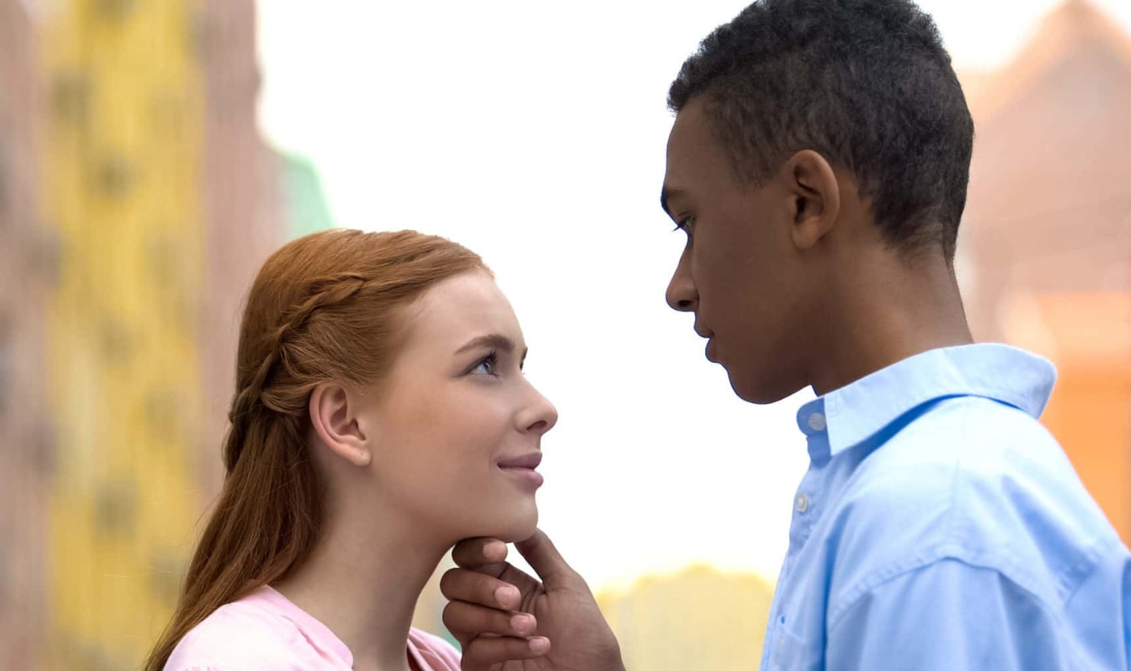 Multiracial Boyfriend Holding Girl Chin, Shutterstock, 1539548831