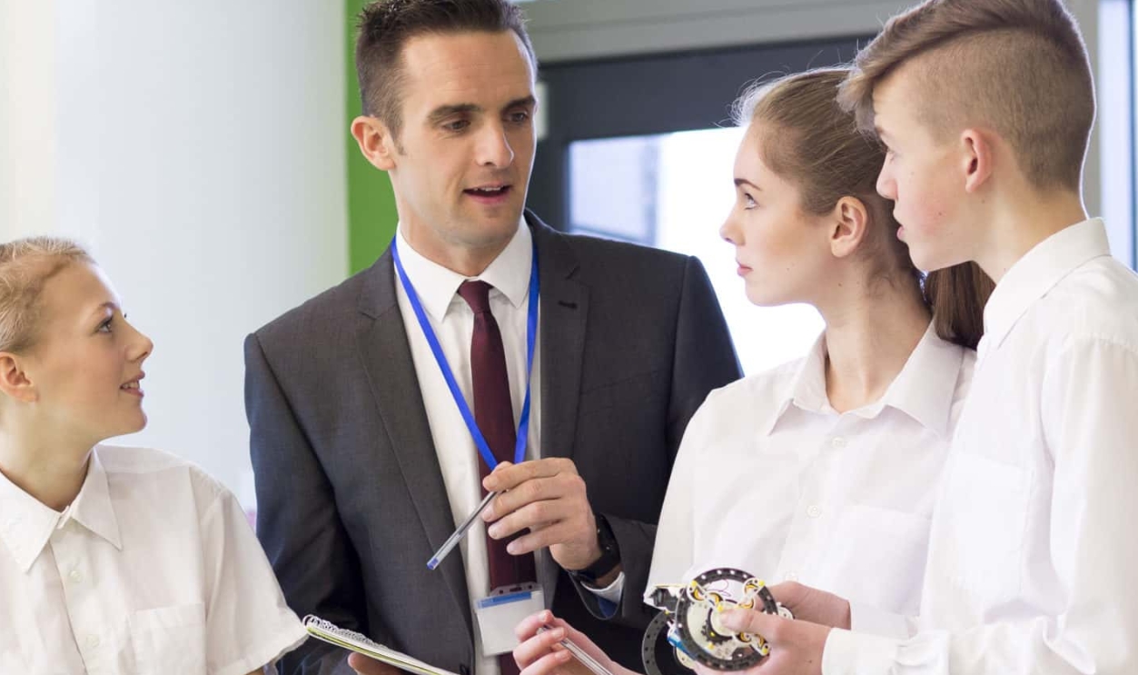 Small Group Of Students Discussing Their Work, Shutterstock, 434081173