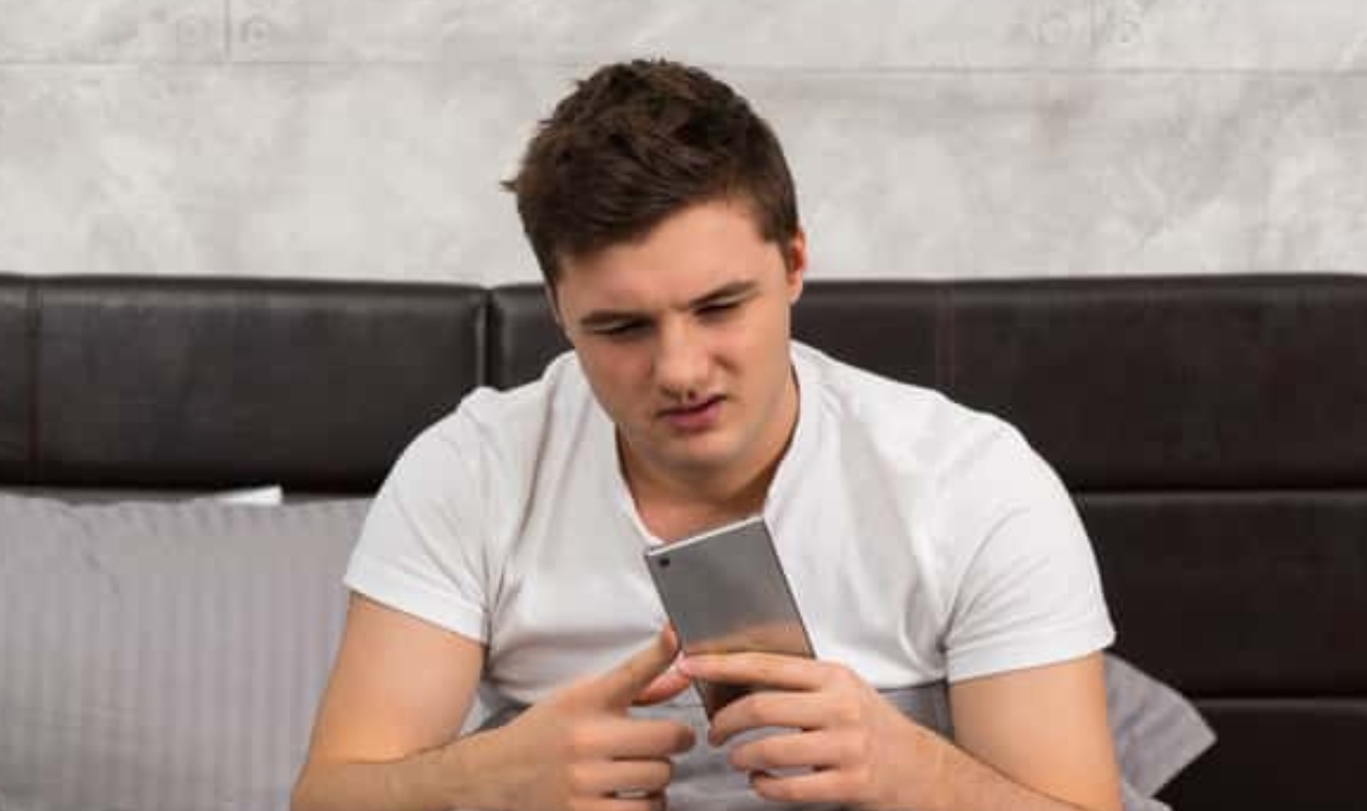 Young Man Woke Up And Looking At His Mobile, Shutterstock, 539278279